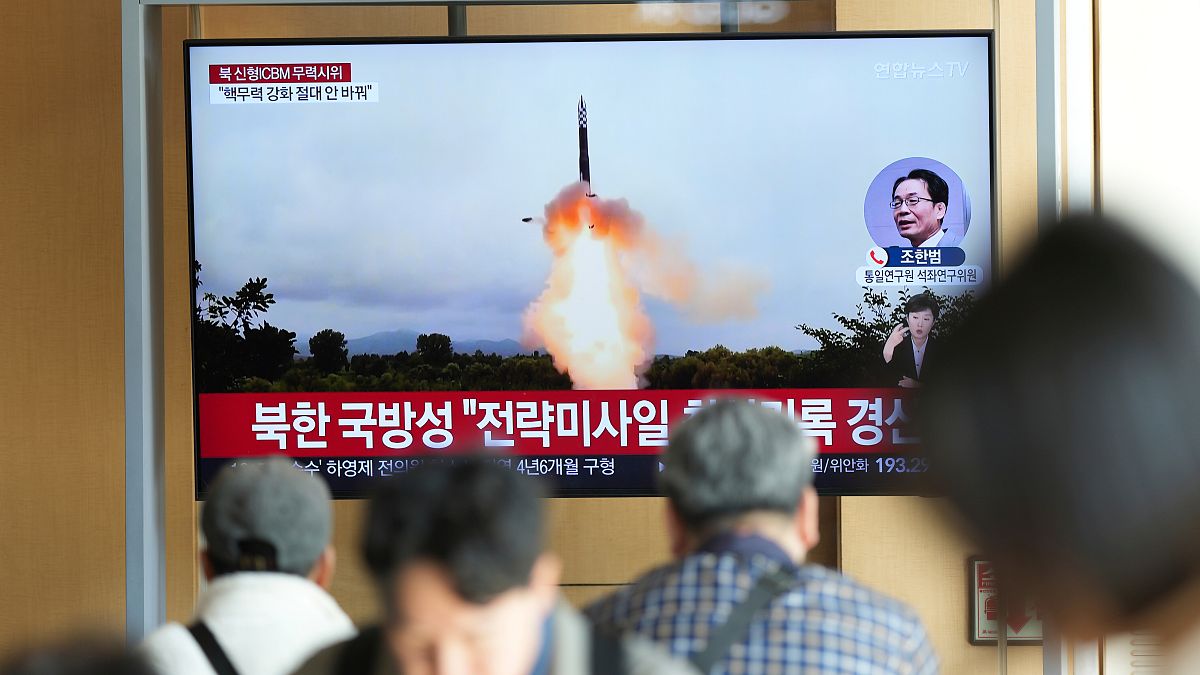 A TV screen shows an image of North Korea