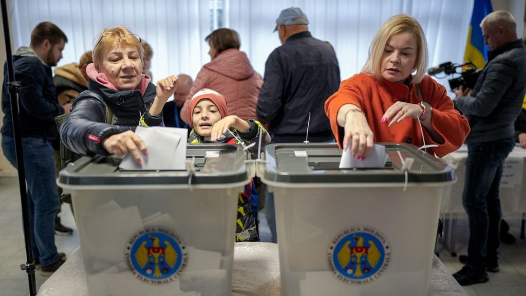 Women cast their ballots at a polling station in the capital Chișinău, 20 October, 2024