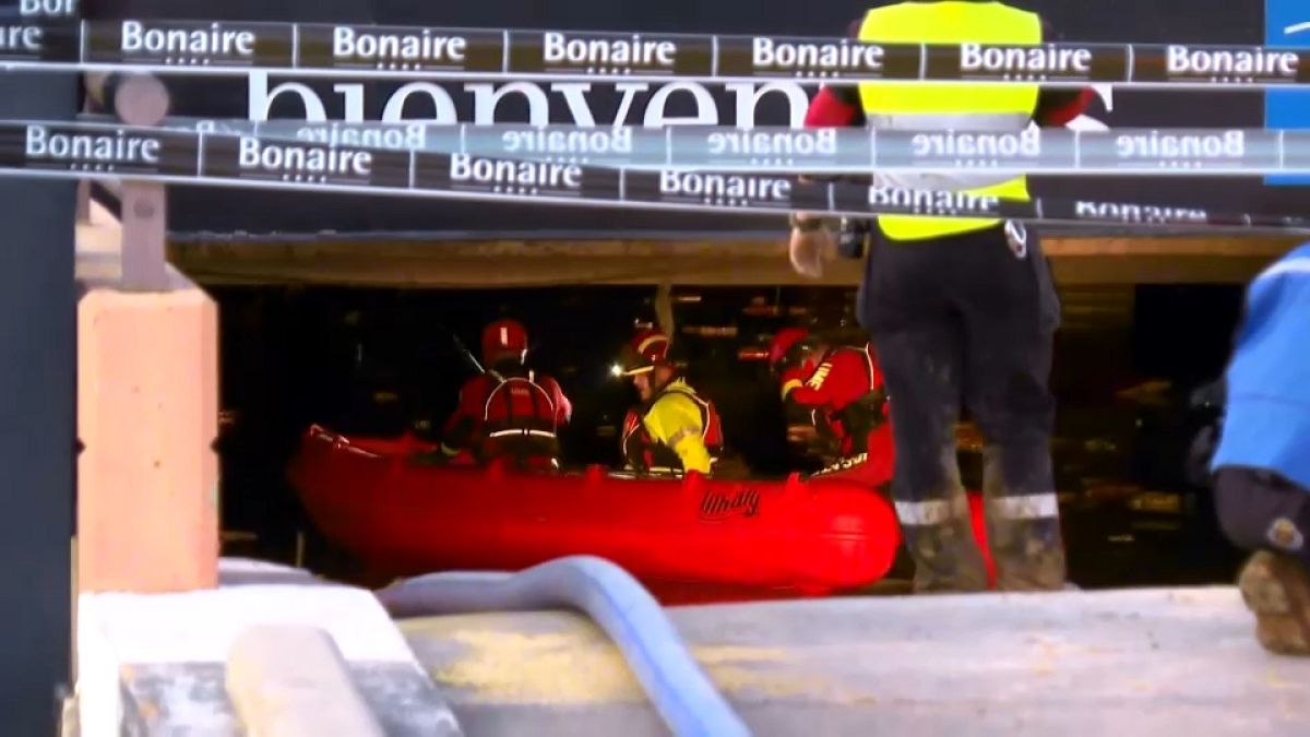 Emergency units sit in a kayak ready to enter the flooded parking lot of the Bonaire shopping center in Valencia.