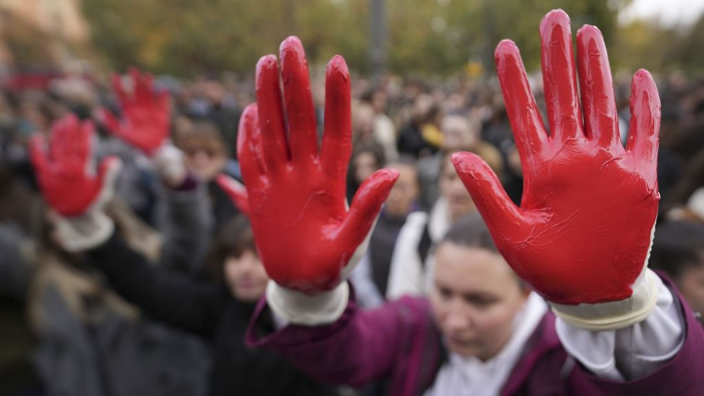 Protesters shout slogans with red paint on their hands two days after a concrete canopy collapsed at a railway station in Novi Sad, 3 November, 2024