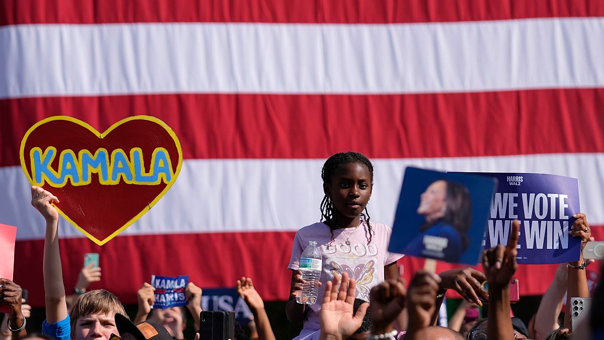 Supporters watch as Democratic presidential nominee Vice President Kamala Harris speaks during a campaign rally outside the Atlanta Civic Center.