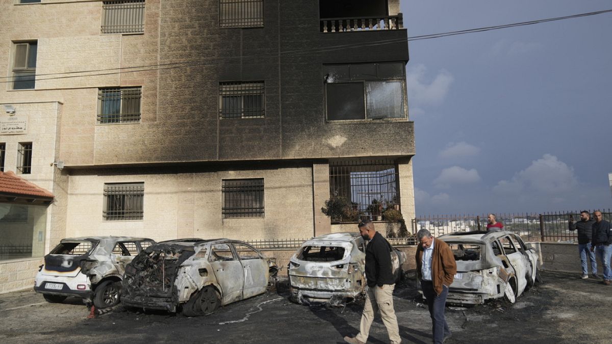 Palestinians inspect vehicles that were burnt during an early morning attack by Israeli settlers, of al-Bireh Monday, Nov. 4, 2024.