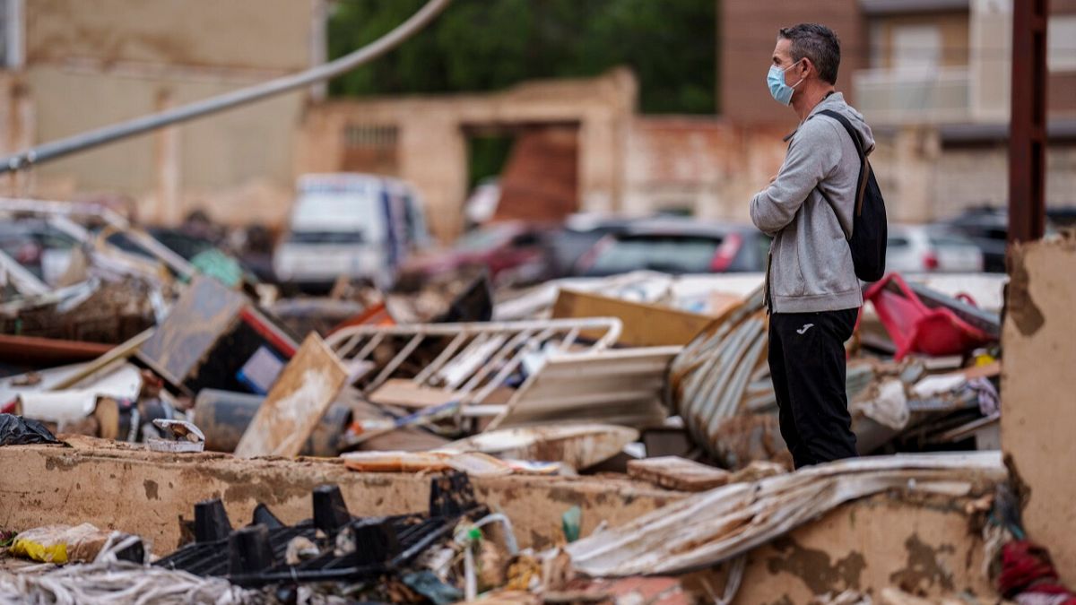 A man looks on the destruction in an area affected by floods in Alfafar, Spain, on Monday, Nov. 4, 2024.