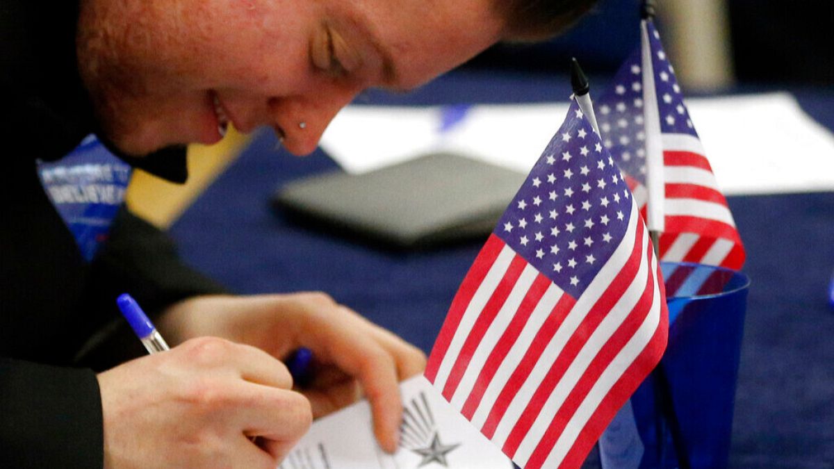 Voters fill out their ballot papers in London, Tuesday, March 1, 2016 as voting begins in the U.S. Democrats Abroad Global Presidential Primary.