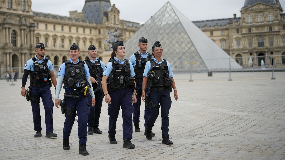 French police patrol a square near the Louvre in Paris ahead of the opening ceremony of the 2024 Summer Olympics, 26 July, 2024