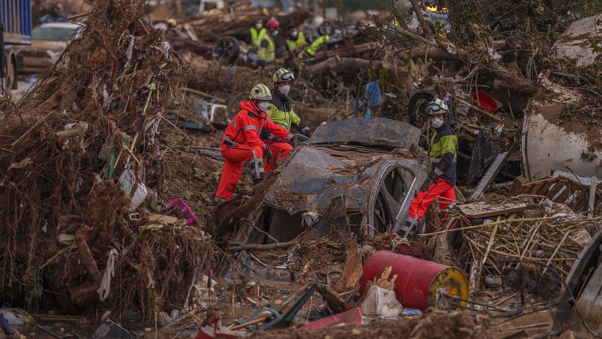 Emergency services remove cars in an area affected by floods in Catarroja, 3 November, 2024