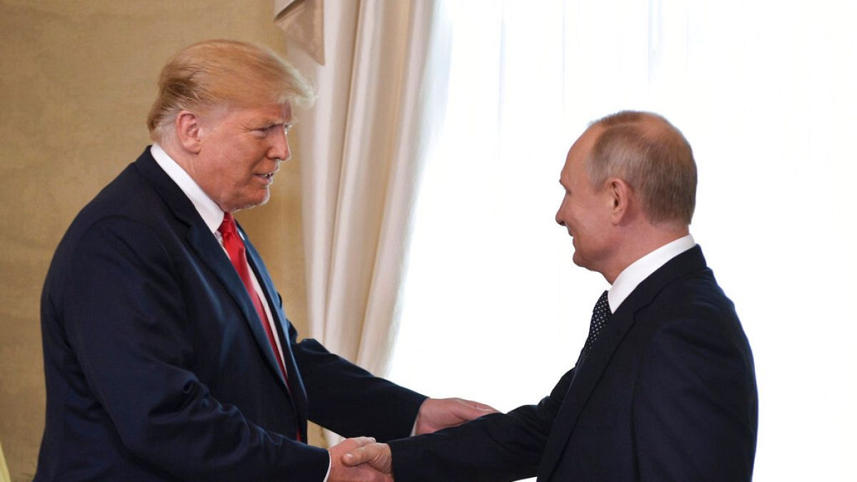 U.S. President Donald Trump and Russian President Vladimir Putin, right, welcome each other at the Presidential Palace in Helsinki, Finland, Monday, July 16, 2018