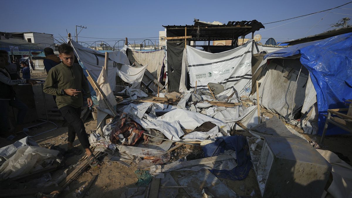 A Palestinian walks through the site of an Israeli strike in the courtyard of the Al-Aqsa Hospital in Deir al-Balah.