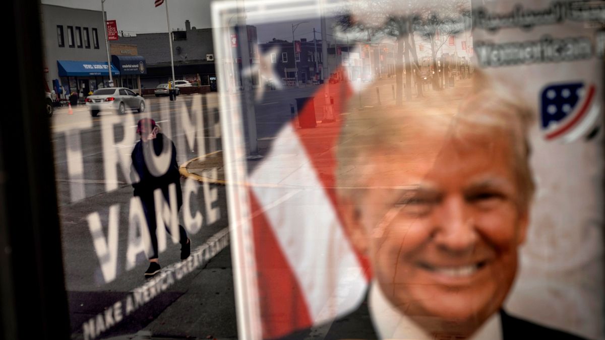 An image of Republican presidential nominee former President Donald Trump hangs in the window of a campaign office.