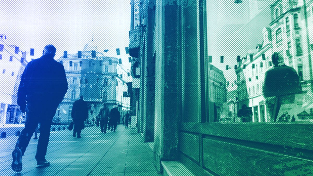 A man walks under European Union flags placed in one of the main streets in Sarajevo, 21 March 2024