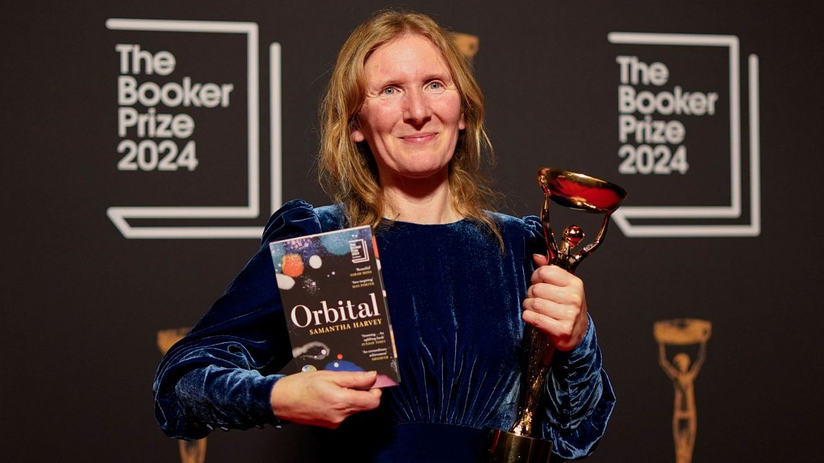 Samantha Harvey poses with the trophy and her book