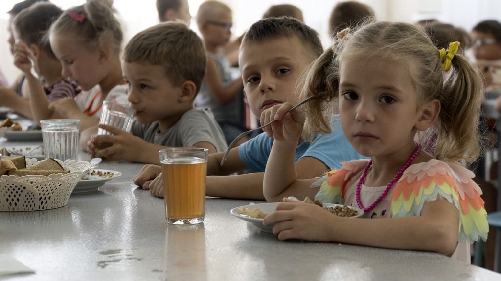 Children from an orphanage in the Donetsk region, eat a meal at a camp in Zolotaya Kosa, the settlement on the Sea of Azov, Rostov region, southwestern Russia