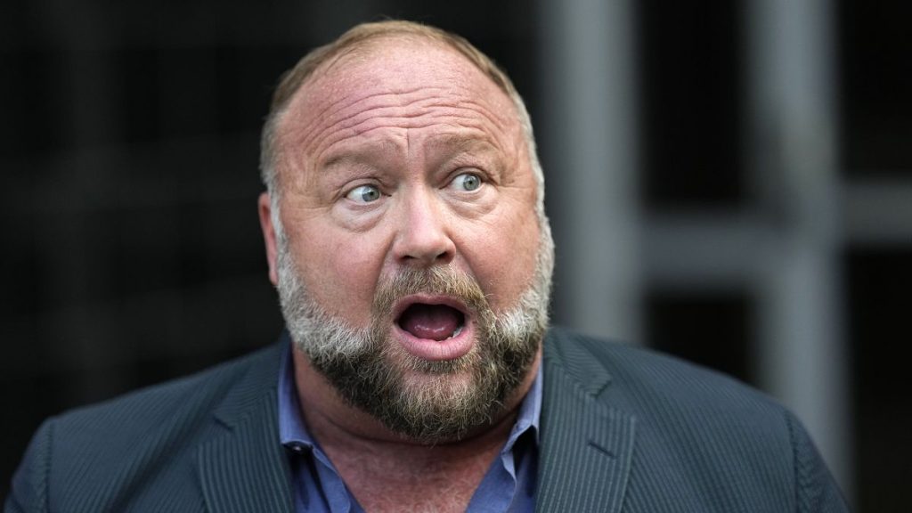 Alex Jones speaks to the media after arriving at the federal courthouse for a hearing in front of a bankruptcy judge Friday, June 14, 2024