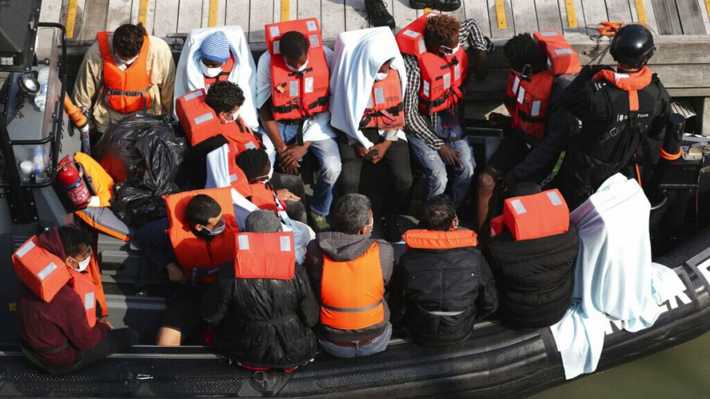 File photo: A group of migrants wait to come ashore at Dover marina in Kent, England, after a small boat incident in the English Channel, Sept. 22, 2020.