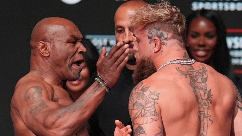 Mike Tyson, left, slaps Jake Paul during the weigh-in ahead of their heavyweight bout, 14 November 2024.