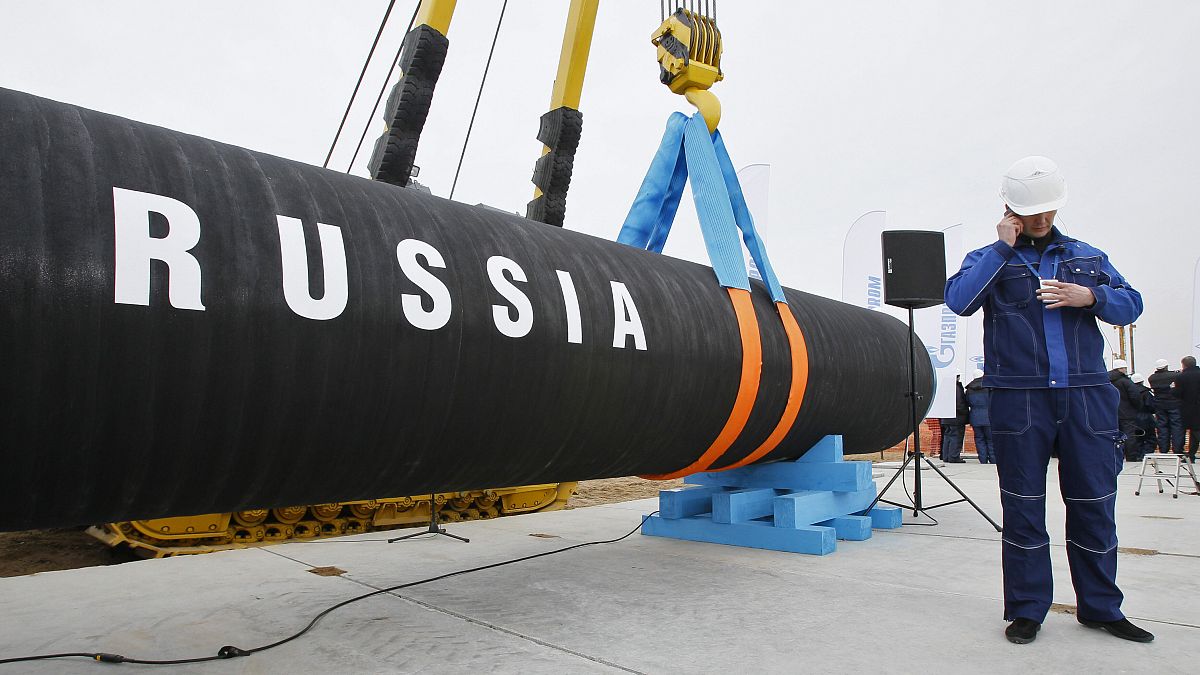 A Russian construction worker speaks on a mobile phone during a ceremony marking the start of Nord Stream pipeline construction in Portovaya Bay, 9 April, 2010