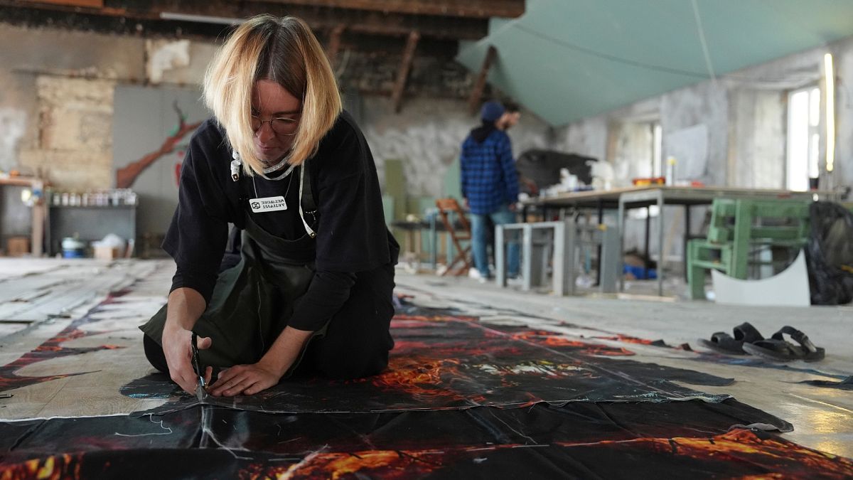 Anna Varszegi, of Budapest, Hungary, works on preparations for a demonstration during COP29.