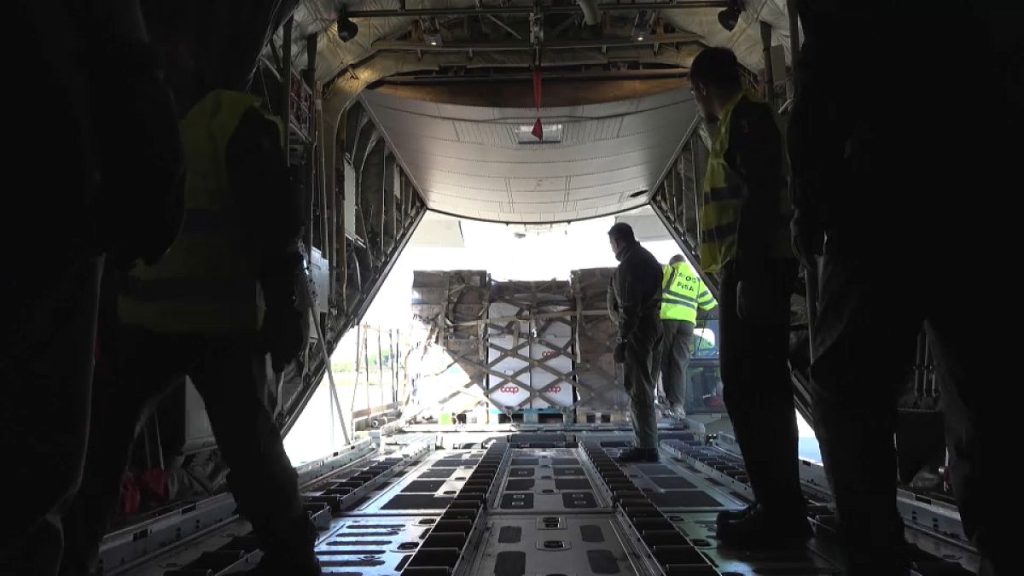 Workers load aid aboard a military plane at an airfield in Pisa, 16 November, 2024