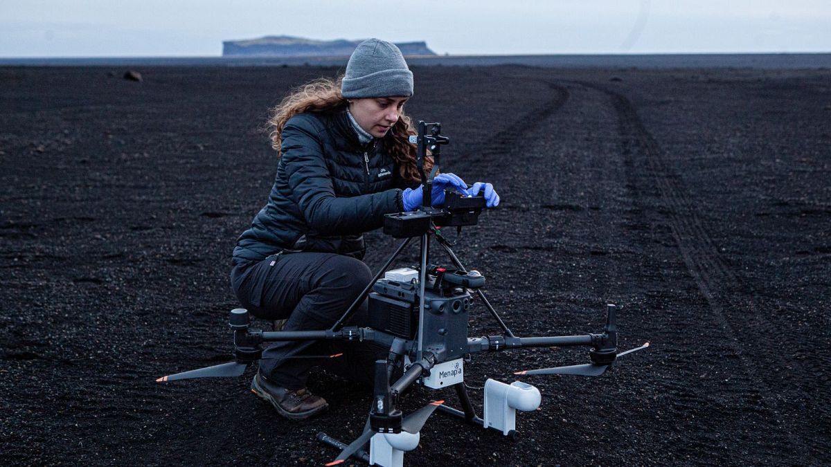 10.	PhD student Polly Foster changes the slides placed on the drone, as several measures at different heights are collected within the Myrdalssandur desert.