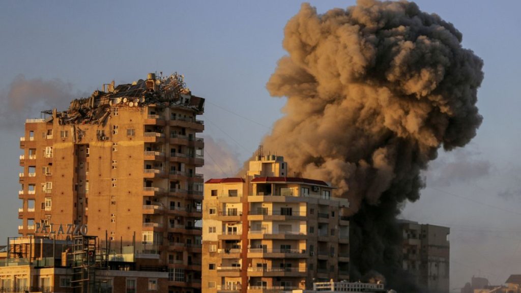 Smoke rises from a building hit in an Israeli airstrike in Tyre, southern Lebanon, Saturday, Nov. 16, 2024. (AP Photo/Mohammed Zaatari)