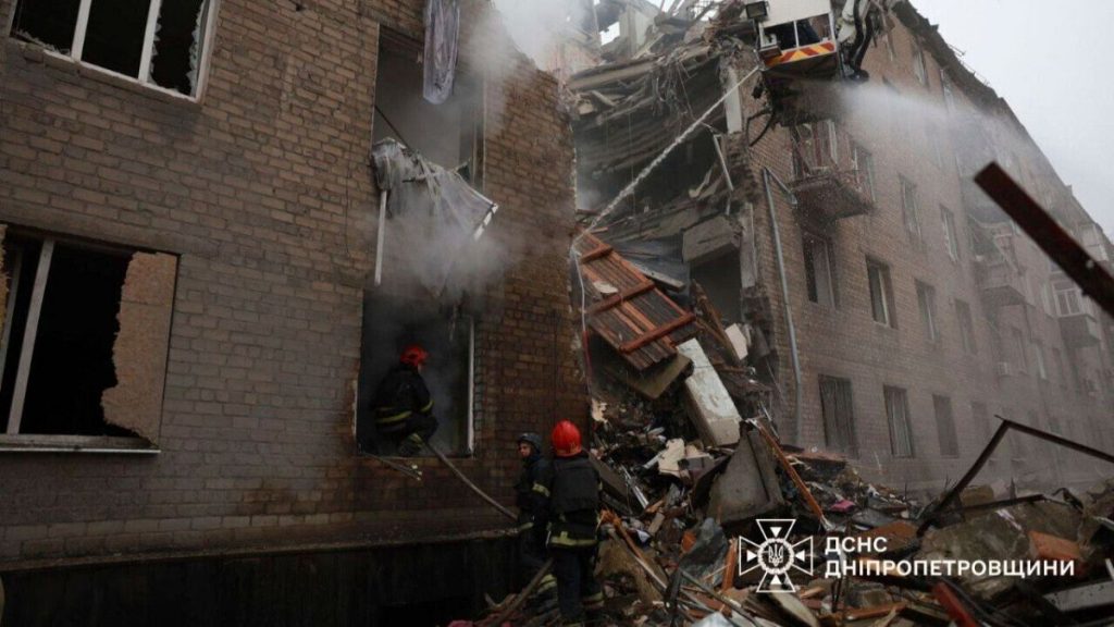 In this image by the Ukrainian Emergency Service on Monday, Nov. 11, 2024, firefighters work on a site of an apartments building destroyed by a Russian attack in Kryv Rih.