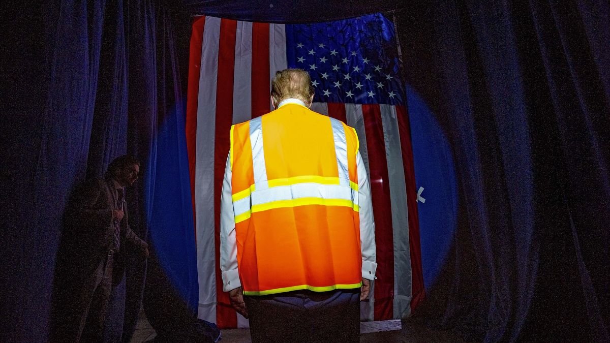 Former President Donald Trump arrives wearing an reflective safety vest for a campaign rally in Winsconsin