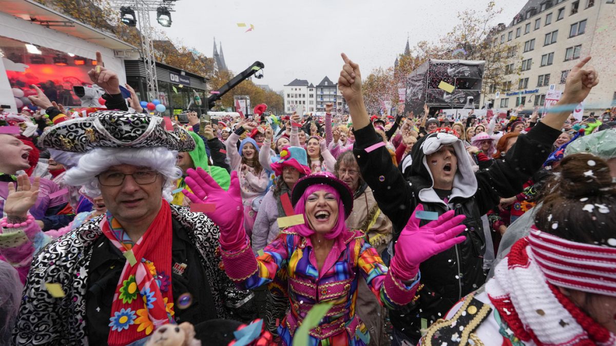 Costumed revelers celebrate at the central Heumarkt while tens of thousands of carnival fools take to the streets of Cologne, Germany, Monday, November 11, 2024