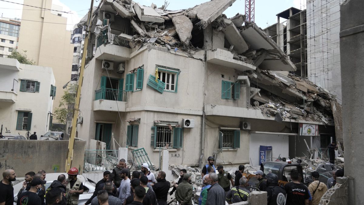 Residents and rescuers gather at the site of an Israeli airstrike that hit a building in central Beirut