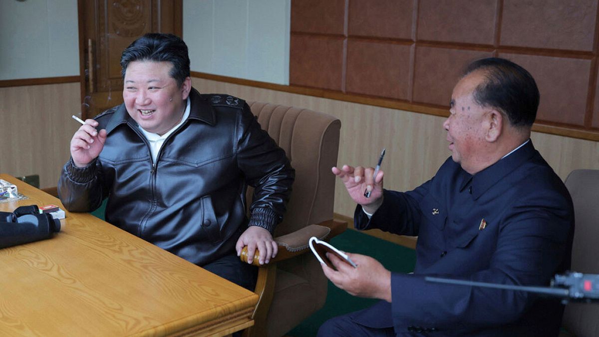 In this photo provided by the North Korean government, its leader Kim Jong Un, left, inspects tests of drones designed to crash into targets, in North Korea.