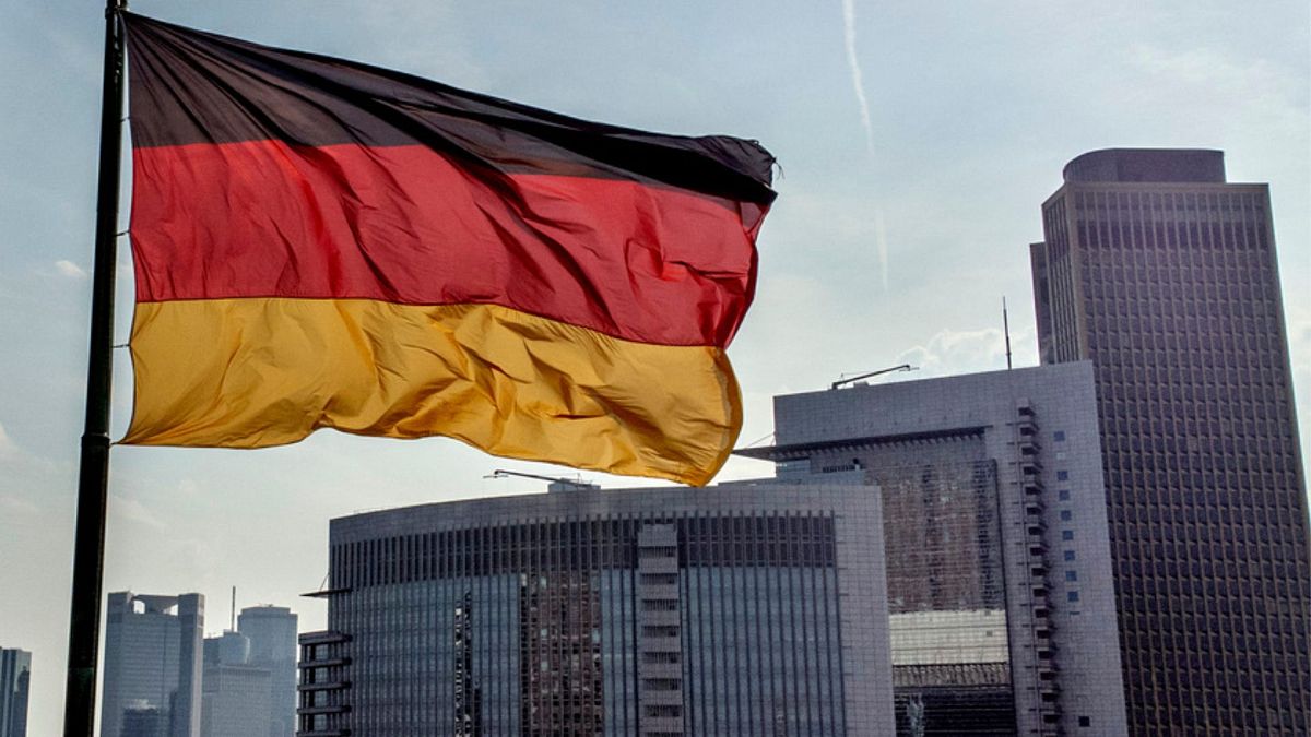 A German flag waves in front of the buildings of the banking district in Frankfurt, Germany, Friday, Aug. 30, 2024.