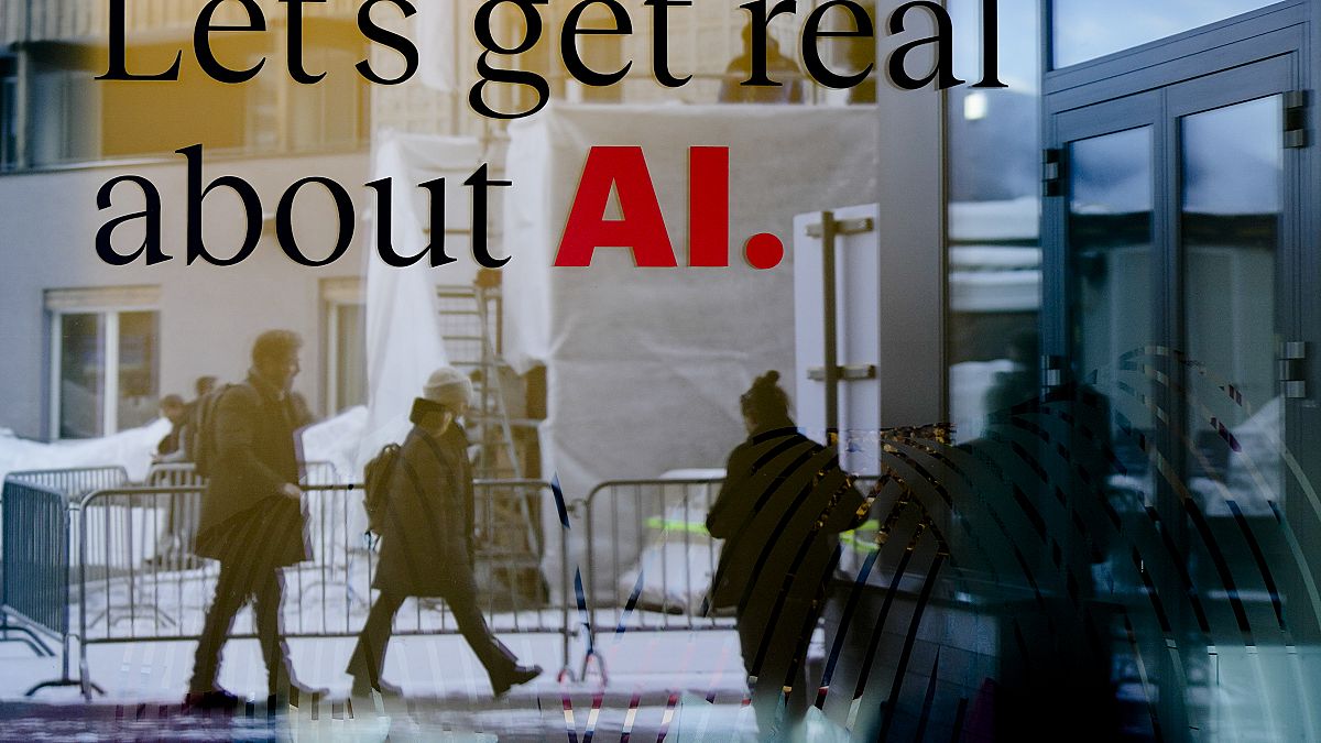 People are reflected in a window of a hotel at the Davos Promenade in Davos, Switzerland, Jan. 15, 2024.