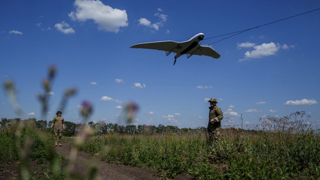 FILE - Ukrainian servicemen of the Ochi reconnaissance unit launch a Furia drone to fly over Russian positions at the frontline in Donetsk region, Ukraine, June 30, 2024