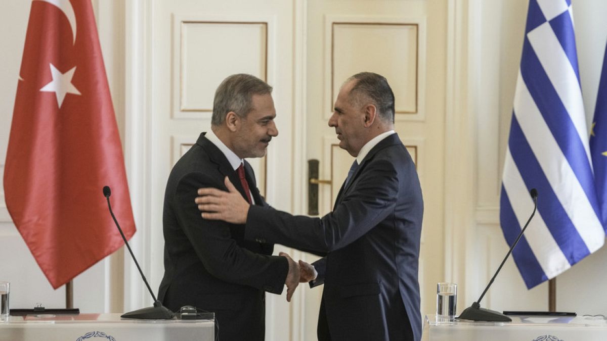 Greek Foreign Minister George Gerapetritis, right, embraces his Turkish counterpart Hakan Fidan after their meeting in Athens, Greece, Friday, Nov. 8, 2024