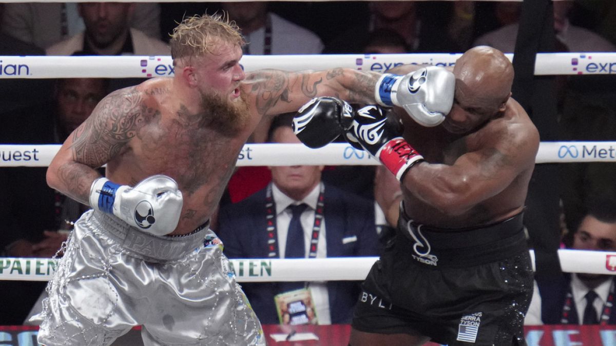 Jake Paul lands a left to Mike Tyson during their heavyweight boxing match, Friday, Nov. 15, 2024, in Arlington, Texas. (AP Photo/Julio Cortez)