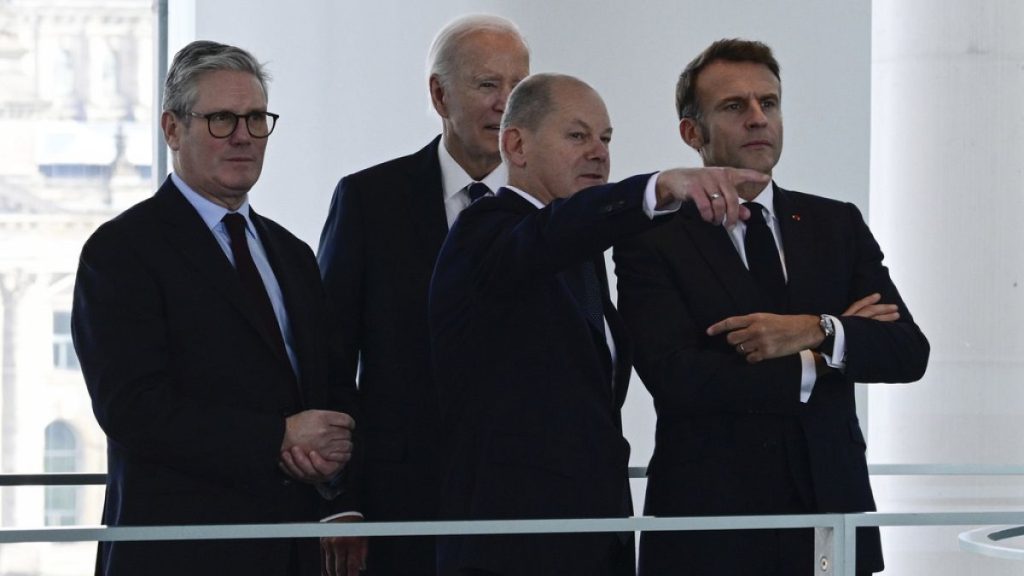 Keir Starmer, Joe Biden, Olaf Scholz and Emmanuel Macron speak before attending their Quad meeting at the Chancellery in Berlin, Friday Oct. 18, 2024.