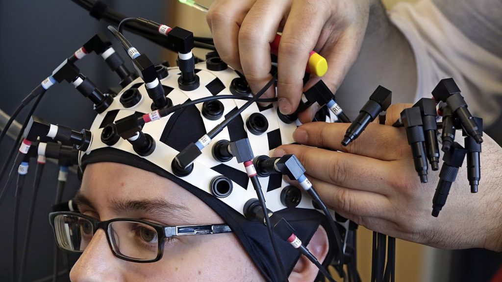 A researcher at the Yale Brain Function Lab has laser probes attached to his head during a demonstration of brain mapping technology in 2015