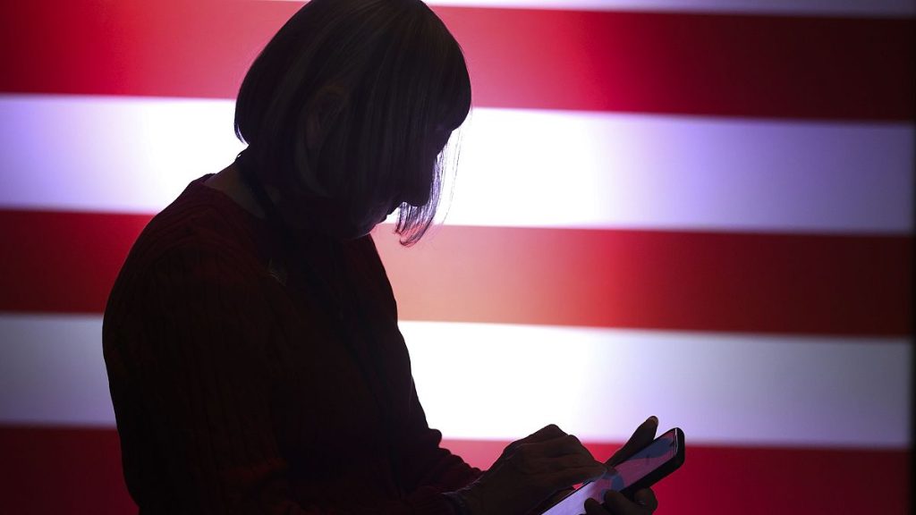 A supporter watches results during an election night watch party in Las Vegas, Nev.