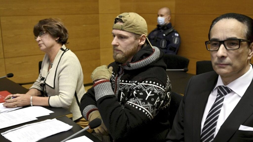 Russian national Yan Petrovsky, who also goes under the name Voislav Torden (center), sits in Helsinki District Court in December 2023