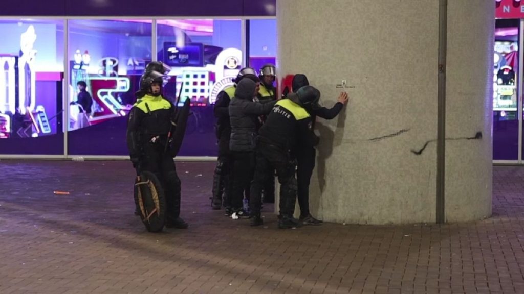 In this image taken from video, police frisk pro-Palestinian supporters near the Ajax stadium in Amsterdam, the Netherlands, Thursday, Nov. 7, 2024.