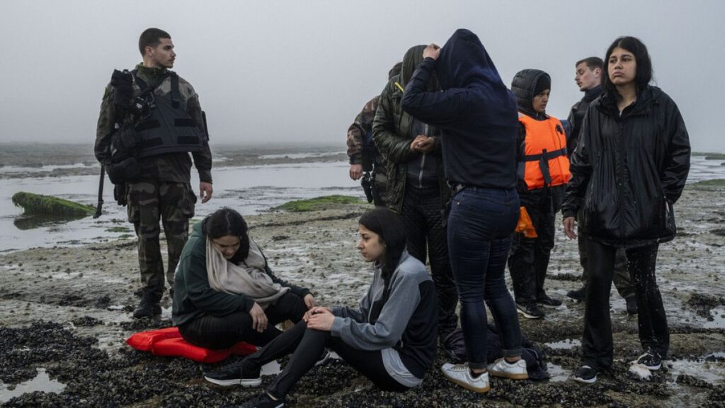 A group of Kurdish migrants from Iran and Iraq who failed in their attempt to reach the United Kingdom by boat rest on the beach of Ambleteuse, northern France on May 19 2024.