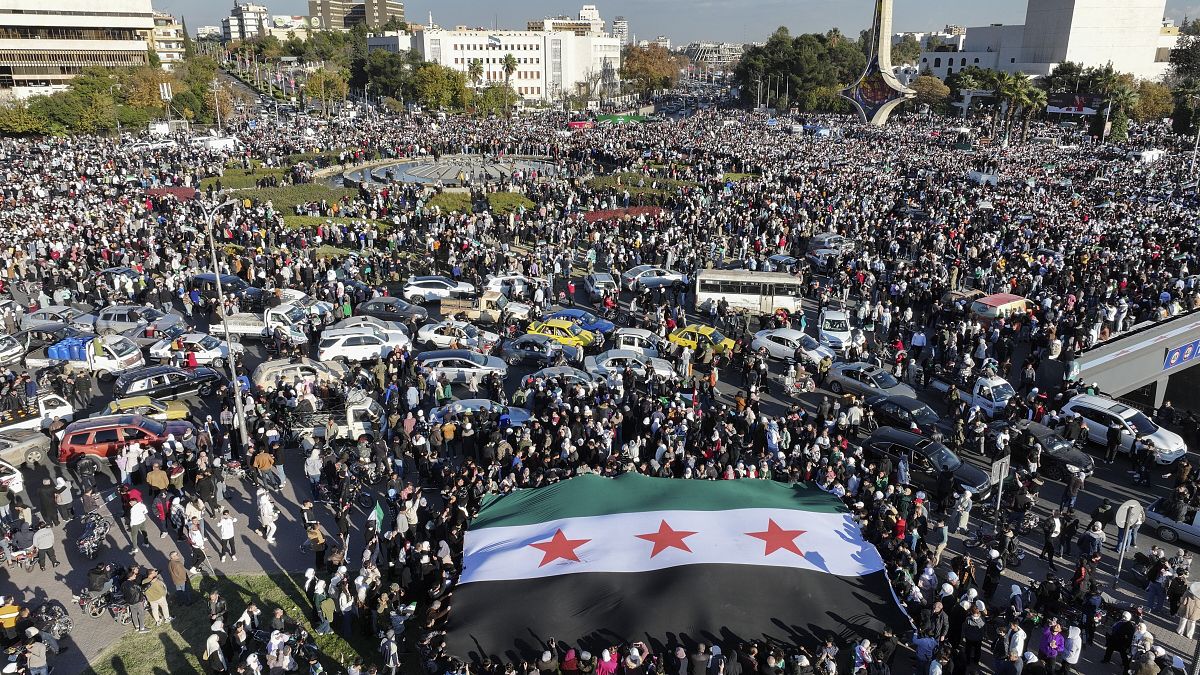 Syrians gather during a celebratory demonstration following the first Friday prayers since Bashar al-Assad