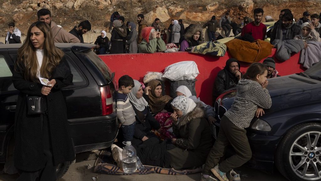 Syrians wait on the road to cross into Lebanon near the Masnaa crossing, 11 December, 2024