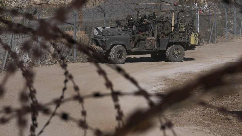 Israeli soldiers stand on an armoured vehicle before moving towards the so-called Alpha Line that separates the Israeli-controlled Golan Heights from Syria, 15 December, 2024