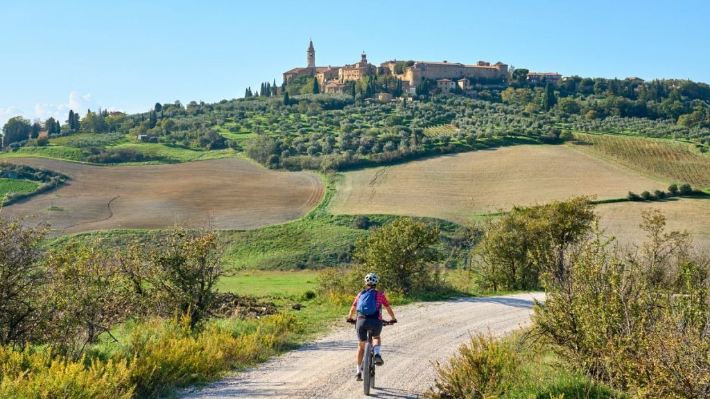 Cyclist in the Ghianti region near the medieval city of Pienza, Tuscany, Italy