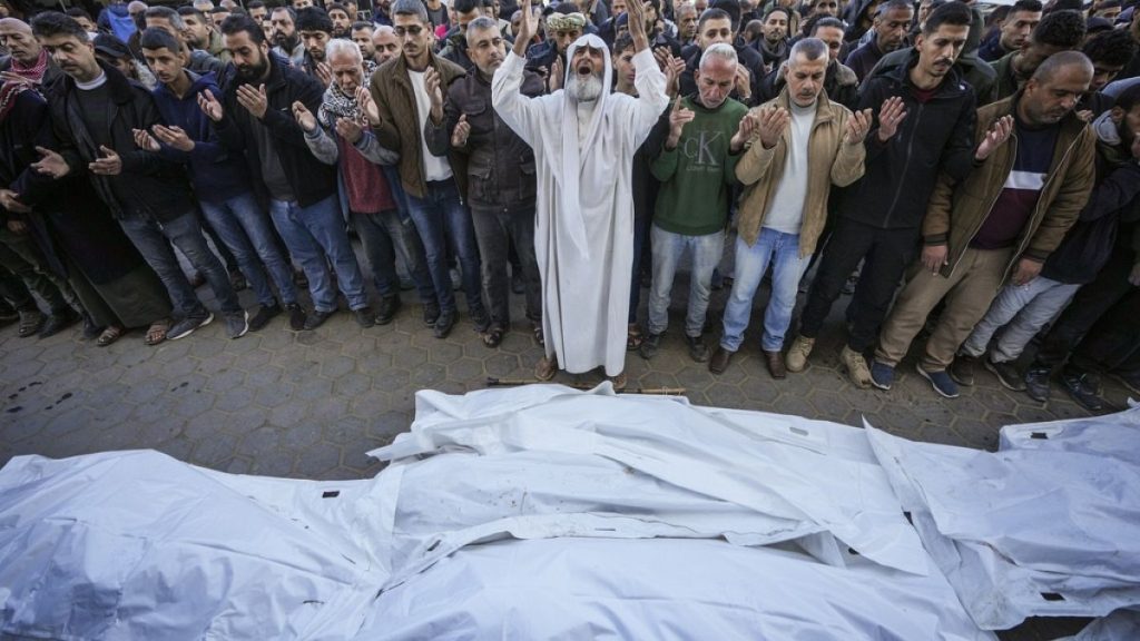 Palestinians pray over bodies of victims of an Israeli strike on a home late Saturday before the funeral outside the Al-Aqsa Martyrs Hospital in Deir al-Balah, Dec 22nd 2024