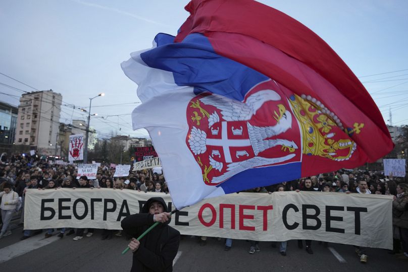 Des gens assistent à une manifestation contre les autorités serbes à Belgrade, en Serbie, le dimanche 22 décembre 2024. (AP Photo/Darko Vojinovic)