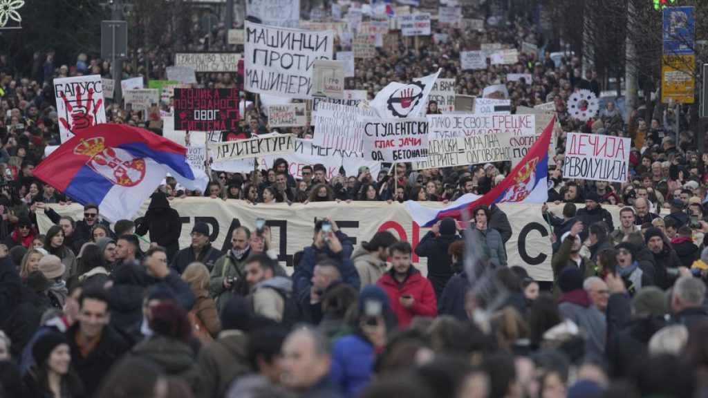 People attend a protest against the Serbian authorities in Belgrade, Serbia, Sunday, Dec. 22, 2024. (AP Photo/Darko Vojinovic)