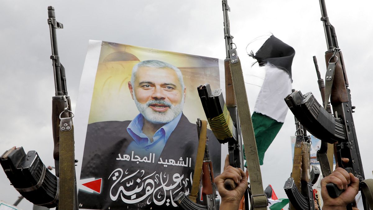 Yemeni protesters raise their machine guns during a protest to condemn the killing of Hamas leader Ismail Haniyeh, in Sanaa, 2 August 2024