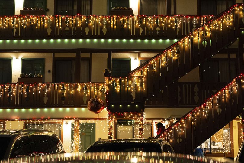 Une personne portant un chapeau sur le thème de Noël descend les marches de l'Obertal Inn