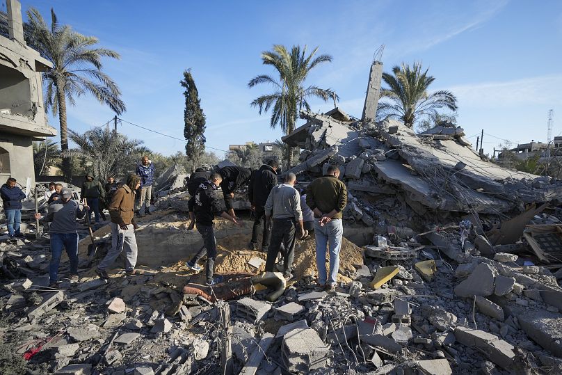 Des Palestiniens regardent leur maison détruite par une frappe israélienne samedi soir à Deir al-Balah, dimanche 22 décembre 2024.